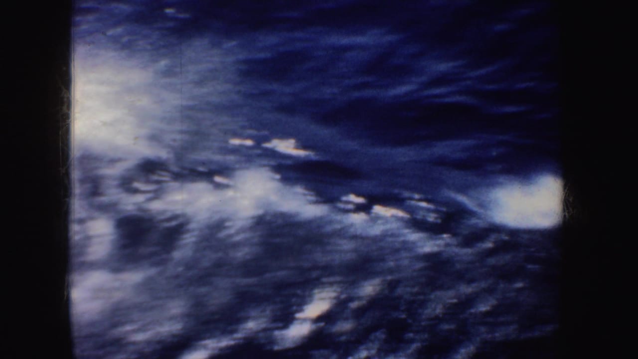 Blue ocean water and white foamy wake seen from a moving boat.