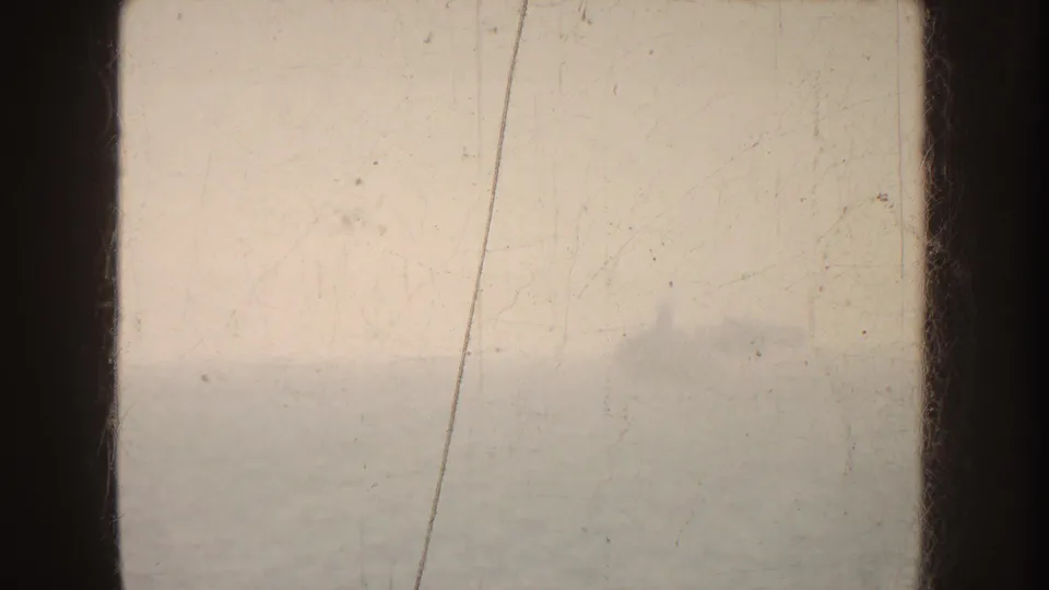 Soft 1952 California coastal view through a boat window, with hazy water and distant horizon.