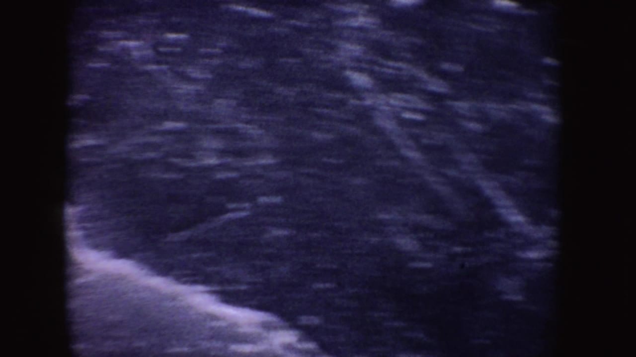 Blue-purple icy ground with a bright edge and heavy film grain.