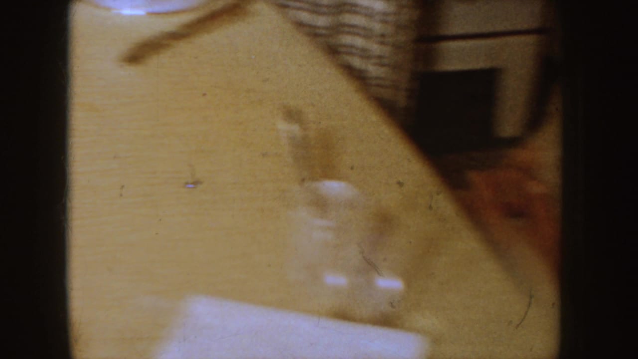 Wooden dining table with part of a seated person at the edge of the frame.