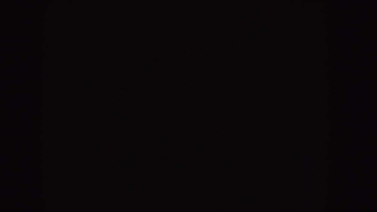Nearly black 8mm frame with faint grain and no visible subjects.