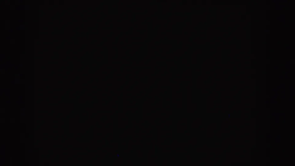 Dark 1955 Idaho 8mm frame showing blank leader-like footage with faint grain and no visible people or objects.