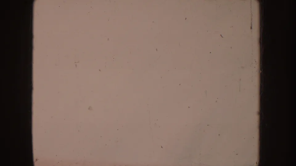 Muted 8mm frame with a mostly blank pale field, visible dust, scratches, and contact-sheet border edges.