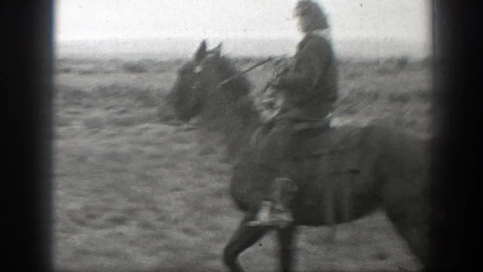 A side view shows the rider seated on horseback in open ranch terrain, framed by dark 8mm gate edges.