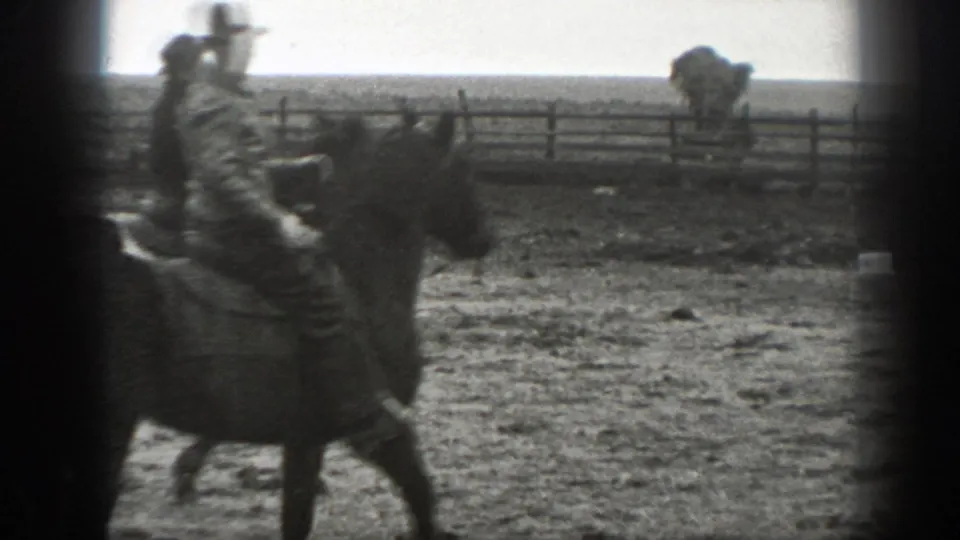 Adult rider in period clothing on horseback in a fenced Montana field, from 1939 8mm home-movie footage.