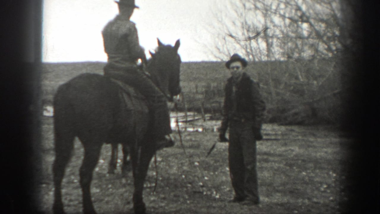 Man on horseback faces a standing man in a rural field with bare trees behind them.