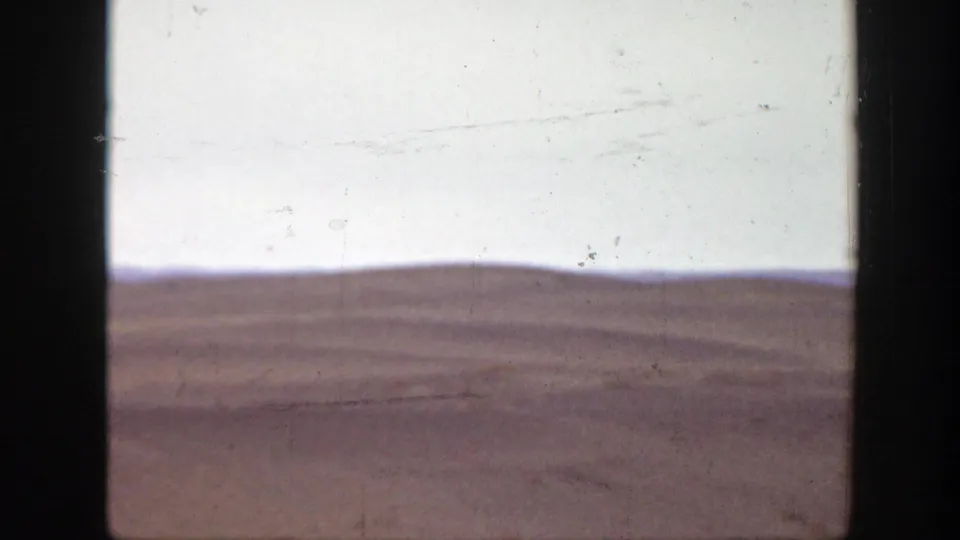 A 1939 Montana landscape view shows open plains and low distant hills, rendered with faded color and visible film wear.