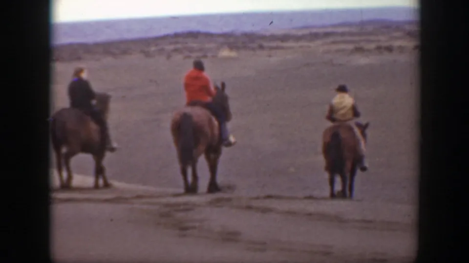Three horseback riders in Montana are seen from behind and at a distance in a 1939 8mm frame.