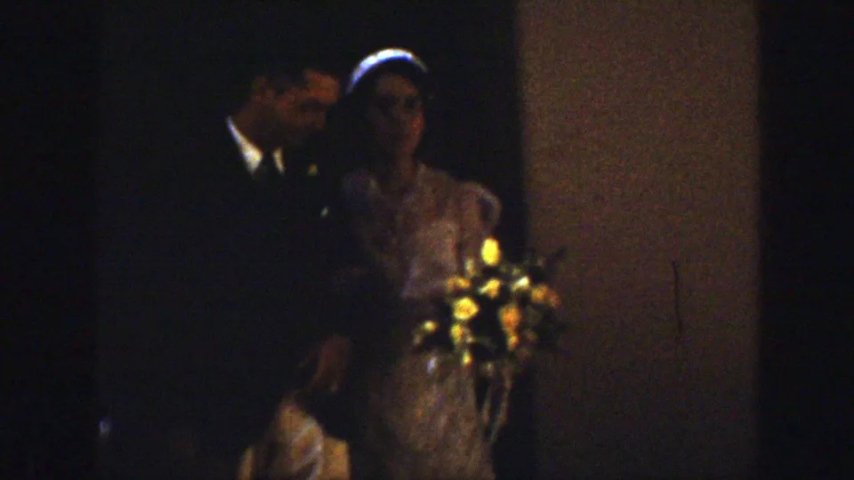 1939 Montana wedding frame with the bride and groom partly in shadow, the bride's veil and bouquet still visible.