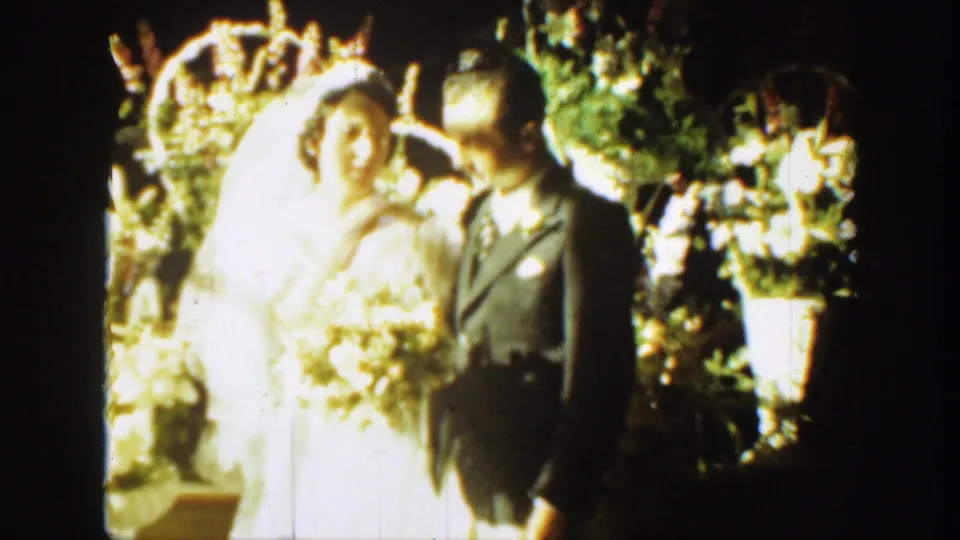 Soft 8mm frame of the bride and groom standing close together at the 1939 Montana wedding.