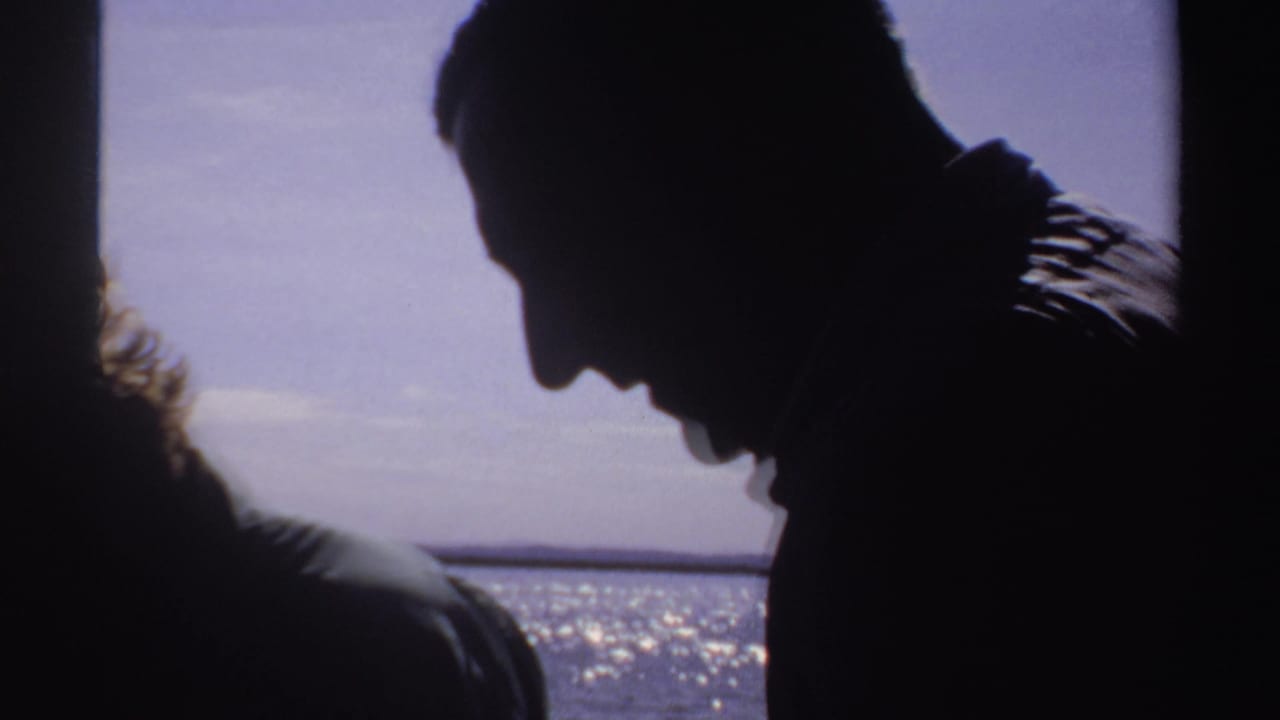 Silhouetted adults inside or beside a boat with bright sea and sky beyond.