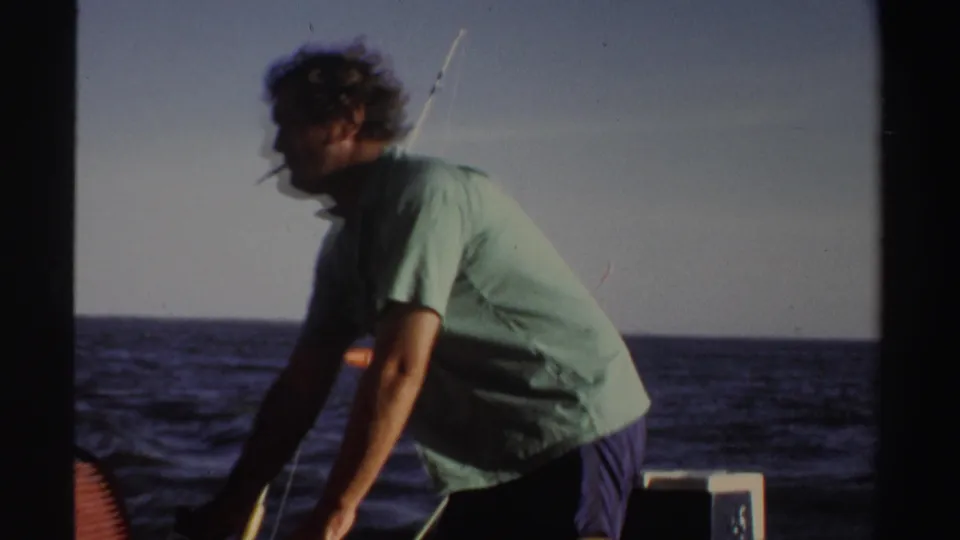 In the 1969 Sudan boat scene, the man bends toward the deck with the horizon and open water visible behind him.