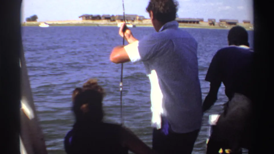 The boat scene continues with the fisherman facing the water, a seated passenger in front, and another figure entering at right.