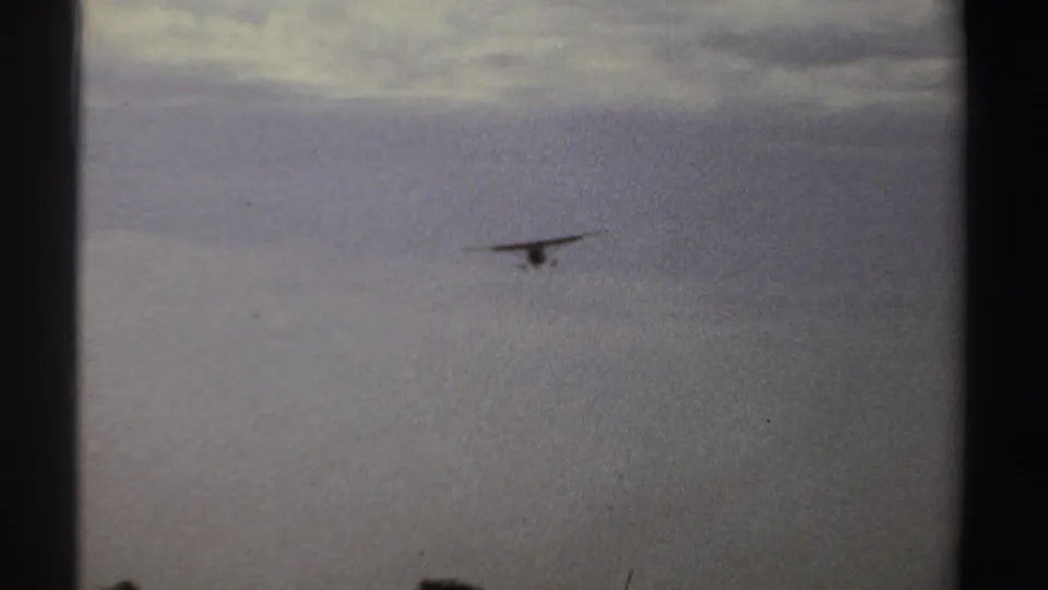 The final 1969 Sudan frame isolates the small plane in a cloudy sky as it flies away from the airstrip scene.