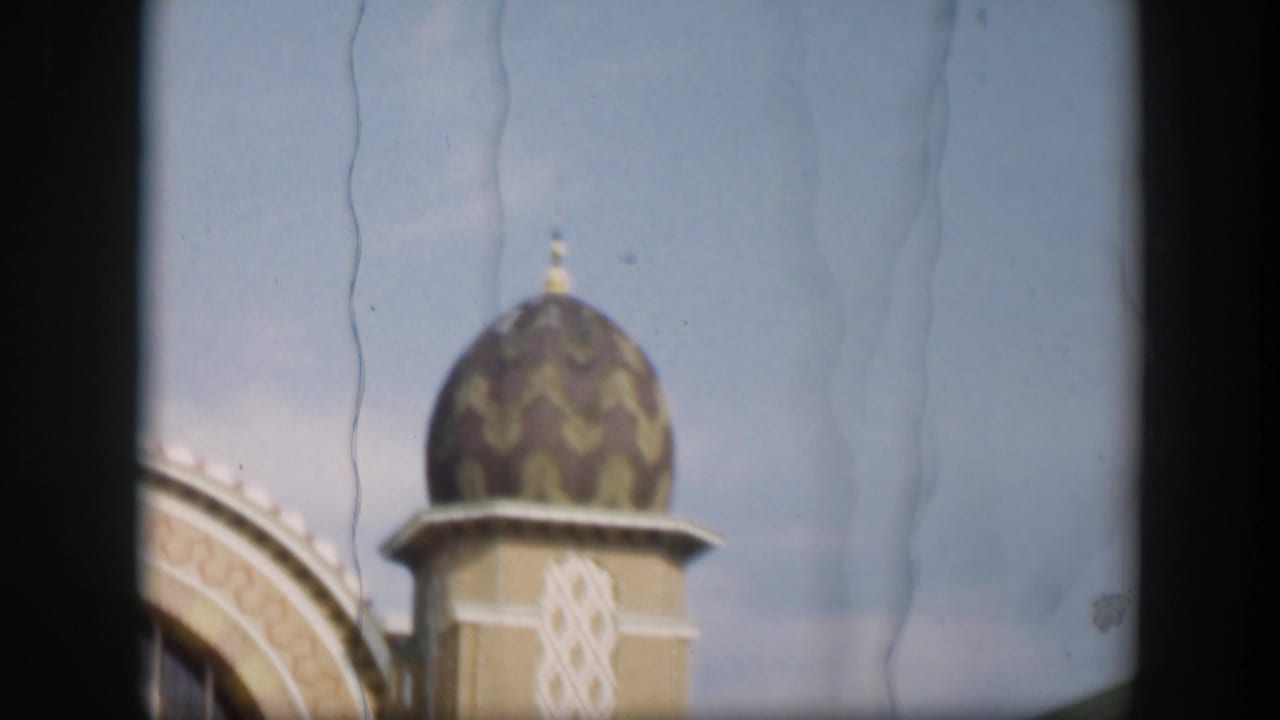 1951 Utah 8mm frame showing a patterned dome and arched trim, possibly part of an Islamic-style building.