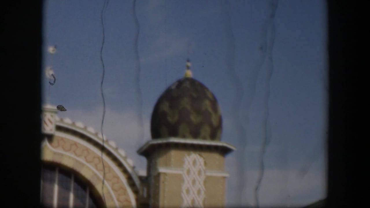 1951 Utah 8mm view of a domed architectural detail with Islamic styling, framed tightly against the sky.