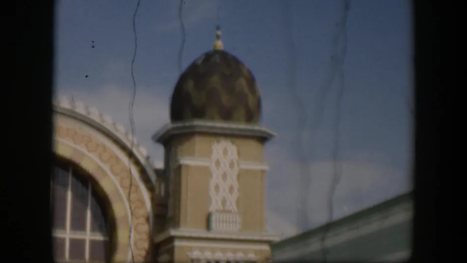 1951 Utah 8mm frame showing an ornate zoo building facade with a patterned dome, arched trim, window, and dark film gate edges.