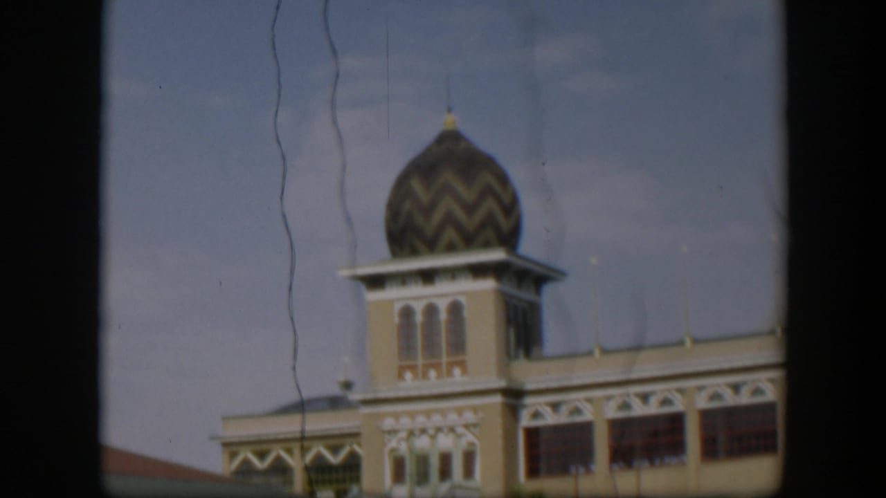 Final 1951 Utah-labeled frame shows the patterned dome and tower shifted right, with arched windows, pale facade, and visible film scratches.