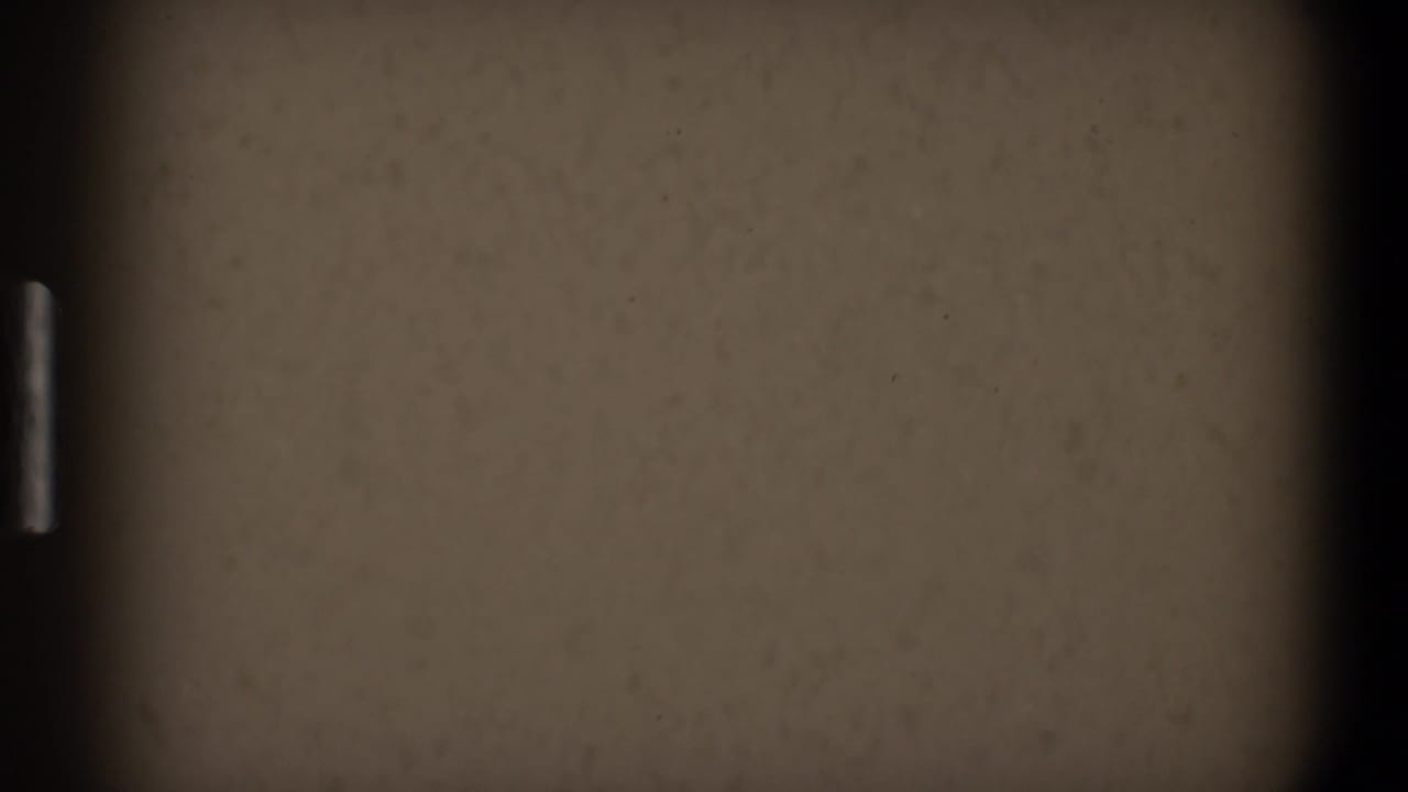 Mostly blank beige surface with a dark vertical strip and pale edge mark.