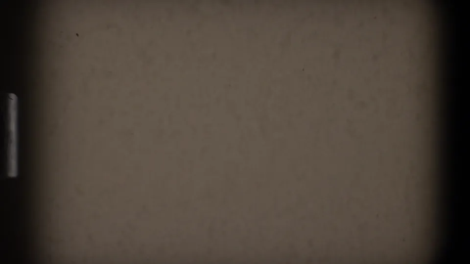1968 Toledo 8mm frame with an empty beige surface, dark right border, muted exposure, dust, and grain.