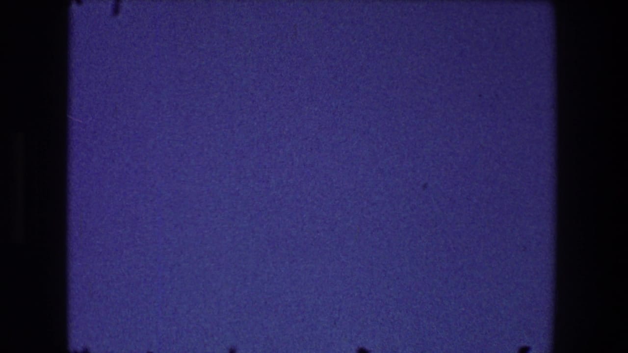 Dark blue grainy sky framed by black film edges.