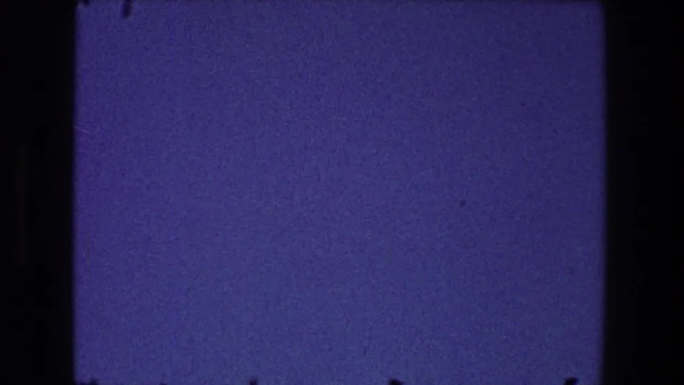 1968 Toledo 8mm frame showing a dark blue sky field with heavy grain and dark gate-edge borders.