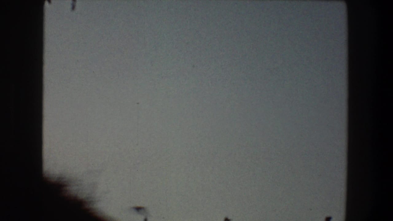 Pale sky with a dark vertical edge and a faint lower silhouette.
