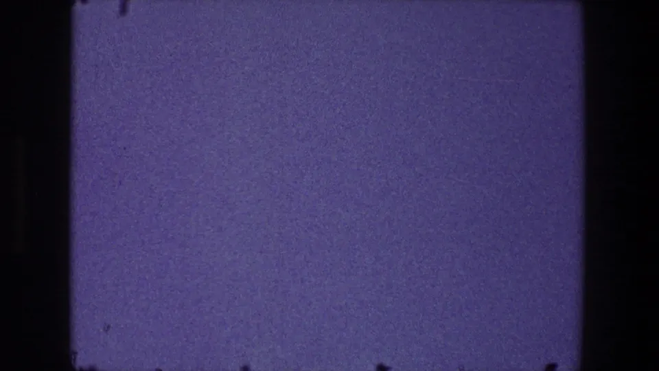 1968 Toledo frame with an open purple dusk sky, visible 8mm frame border, grain, and minor dust marks.