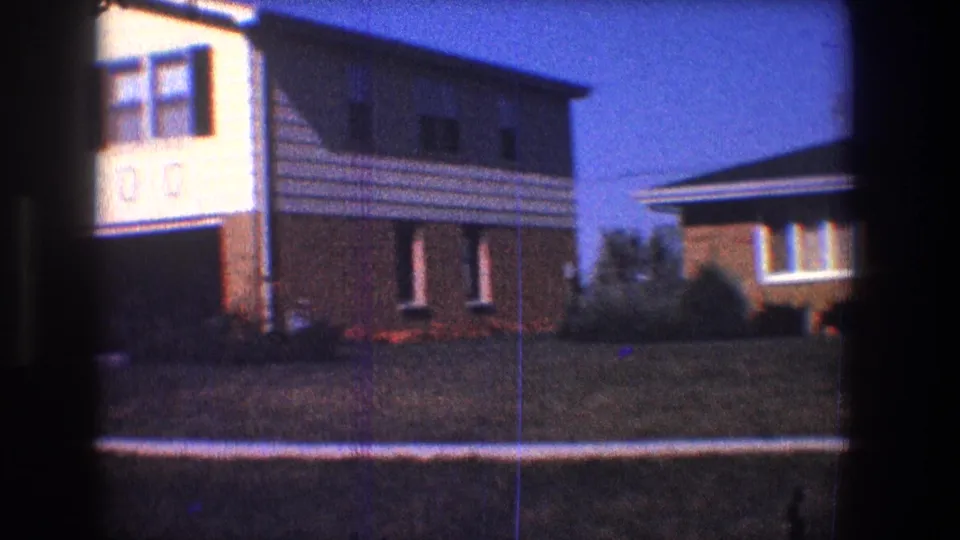 1968 Toledo street view of a two-story suburban house with white siding, brick lower wall, windows, and front lawn.