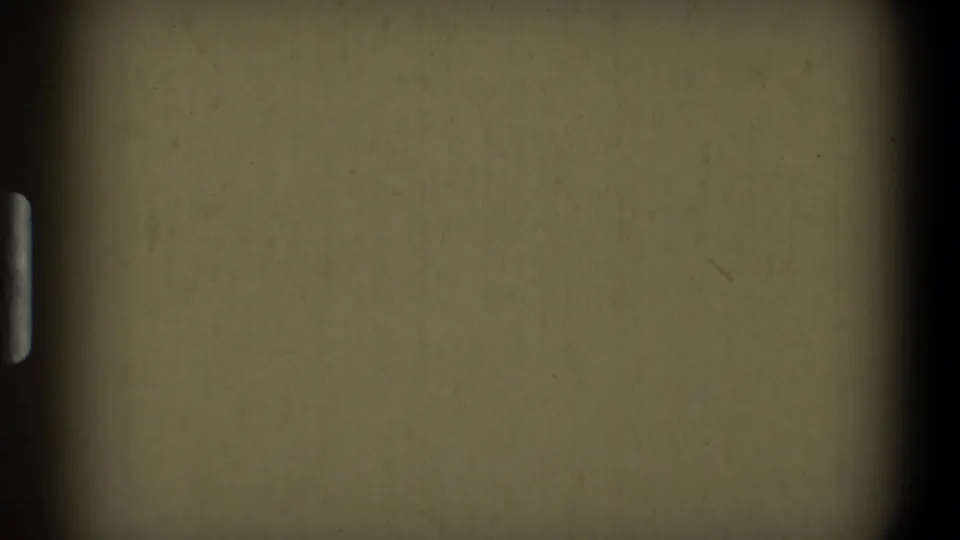 The clip ends on blank 8mm film leader with a muted yellow cast, rounded gate edges, and small surface marks.