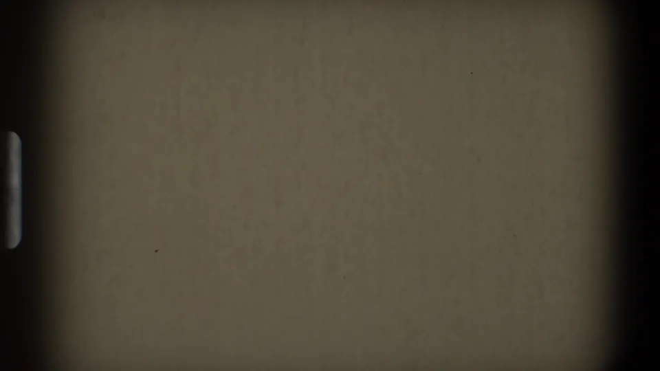 Blank 8mm start-frame segment from the supplied 1968 Toledo clip, with a dark vertical border, sprocket mark, dust specks, grain, and subdued exposure.