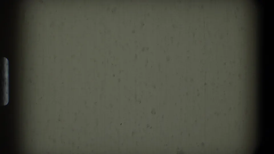 1968 Toledo-source 8mm frame showing gray leader texture, dark edge shadow, dust, and faint exposure variation.