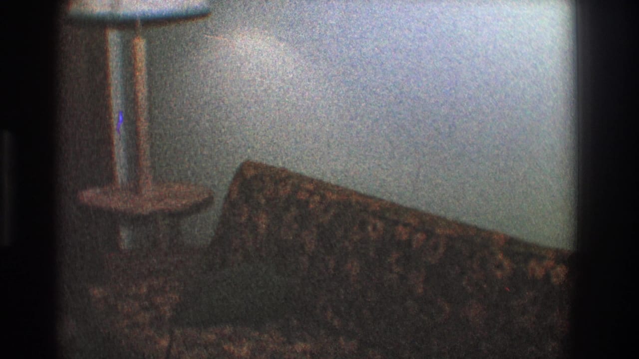 Floor lamp and patterned sofa seen from a slightly shifted angle.