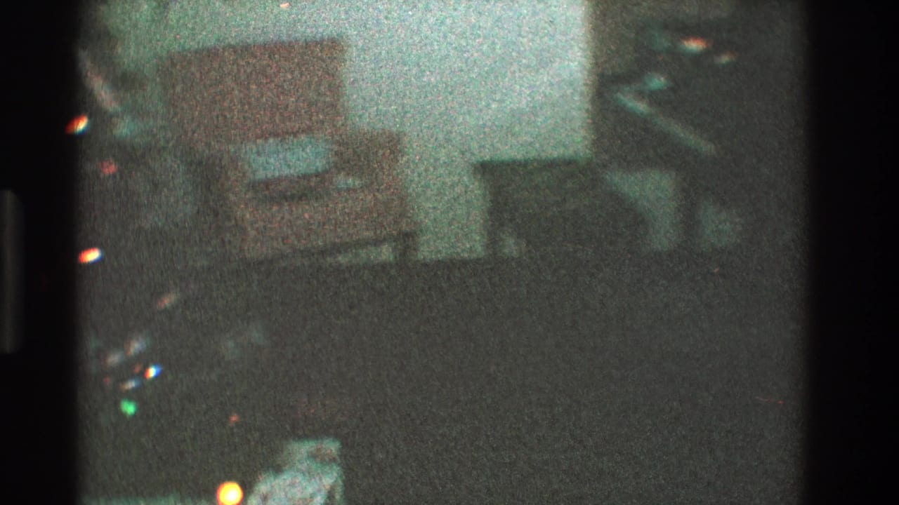 Dim living room with a pale orange chair and a small wrapped gift on the seat.