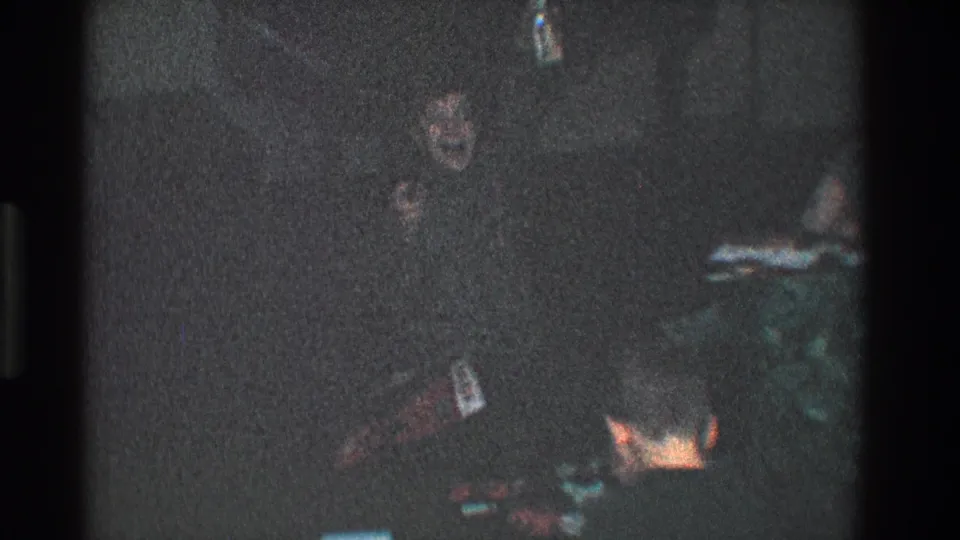 The child appears to face the camera in a dim 1968 Toledo home interior, with scattered items nearby.