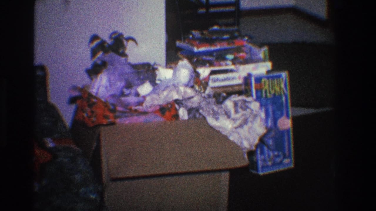 Cluttered box of wrapping paper and colorful packaging in a dim room.