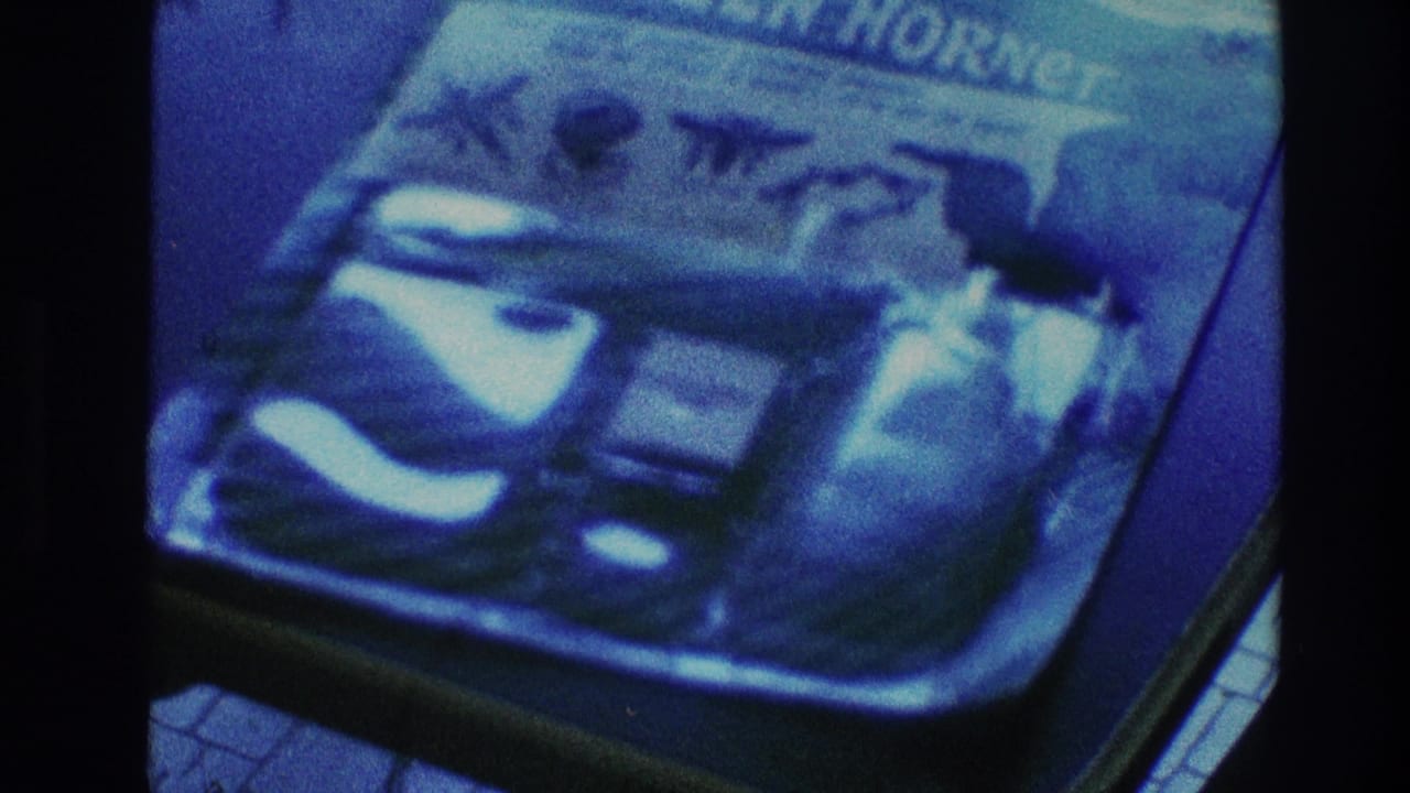 Close view of a blue-tinted package or printed object with household items nearby.