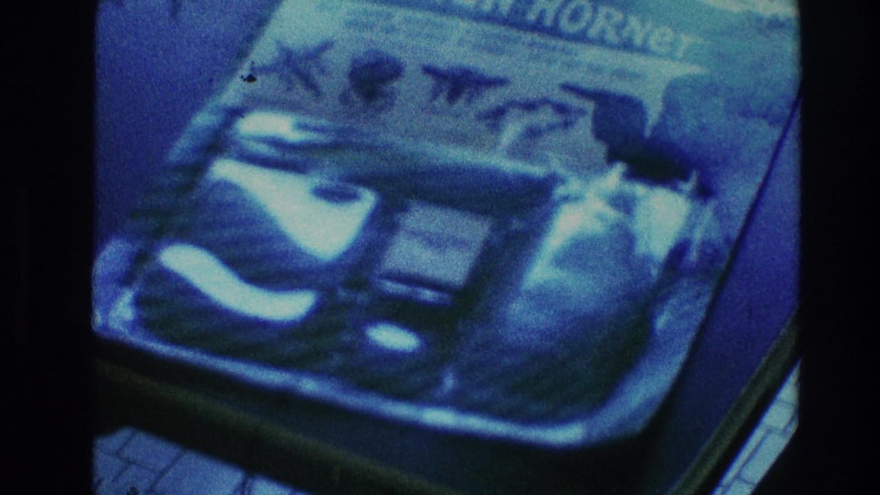 Blue-tinted close view of a printed package or object with partial lettering visible.