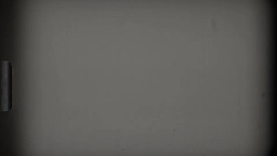 1968 Toledo 8mm frame showing a mostly obscured gray surface, dark vertical borders, and a small handle-like detail near the edge.