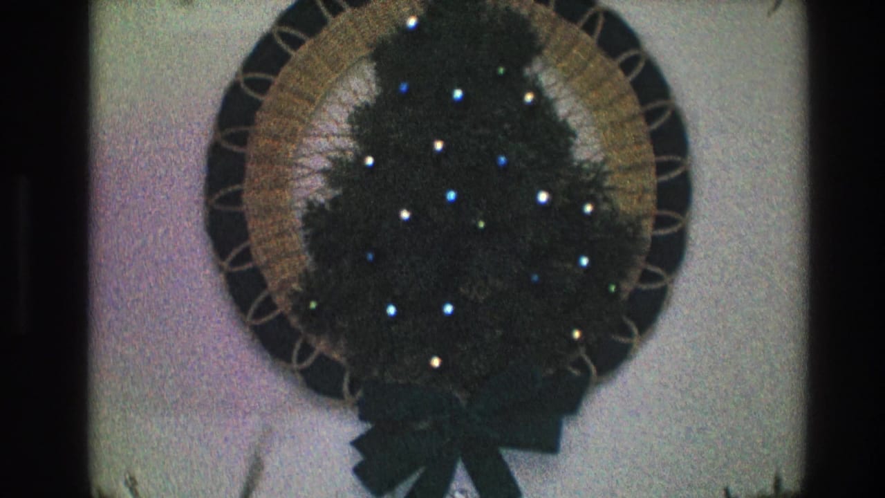 Lit circular wreath centered on an interior wall.