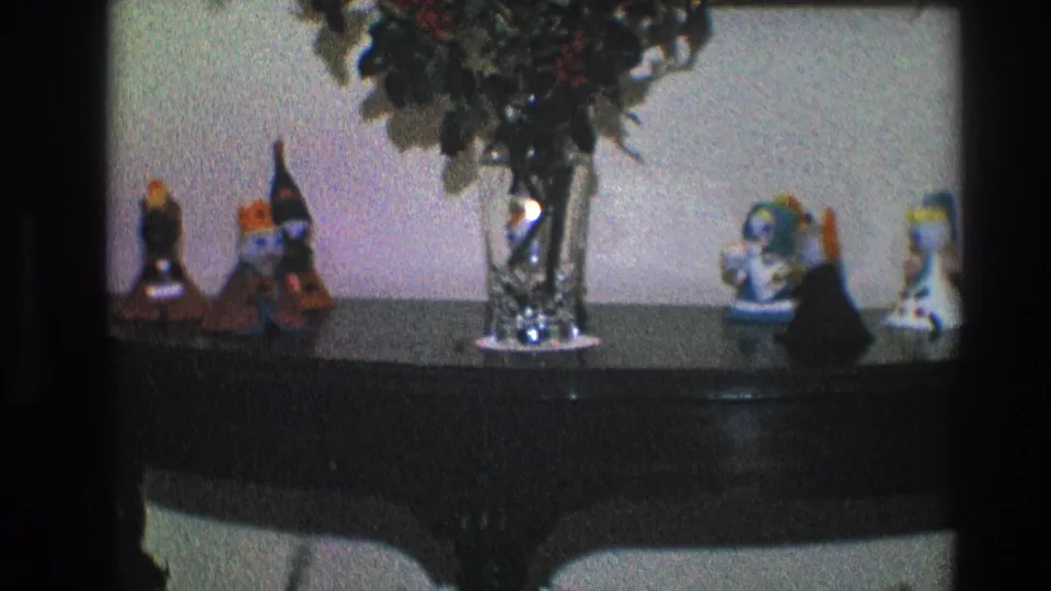 1968 Toledo interior detail with a central glass vase and small decorative figurines arranged on a dark console table.