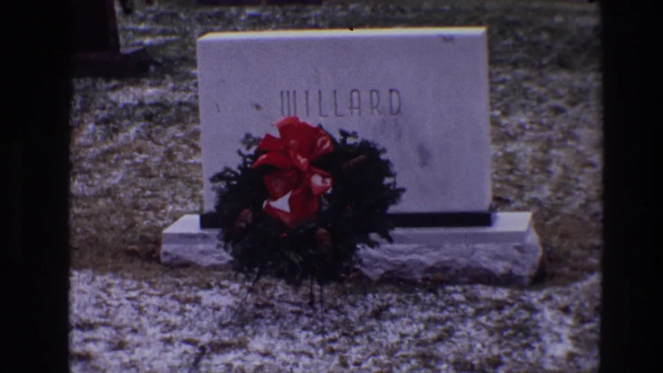 Tight 1968 Toledo cemetery frame of the Willard gravestone and red-bowed wreath at the base.