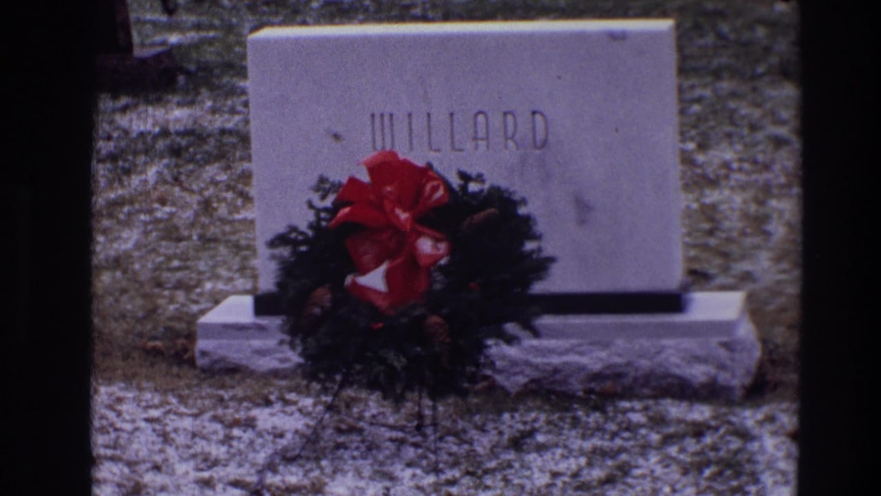 WILLARD gravestone with Christmas wreath, red bow, pinecones, grass, and light snow.