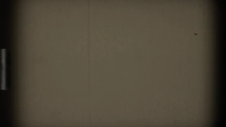 1968 Toledo 8mm home-movie frame showing blank off-white film surface with dark gate edge, dust, and light scratches.
