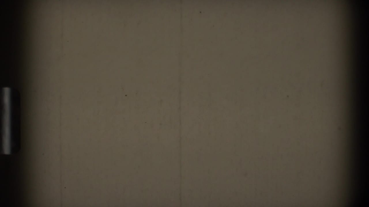 1968 Toledo 8mm frame with a blank off-white field, dark vertical banding, dust spots, and faint surface scratches.