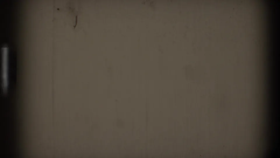 1968 Toledo 8mm frame with blank sepia-toned film texture, dark vertical edges, dust specks, and faint scratches.