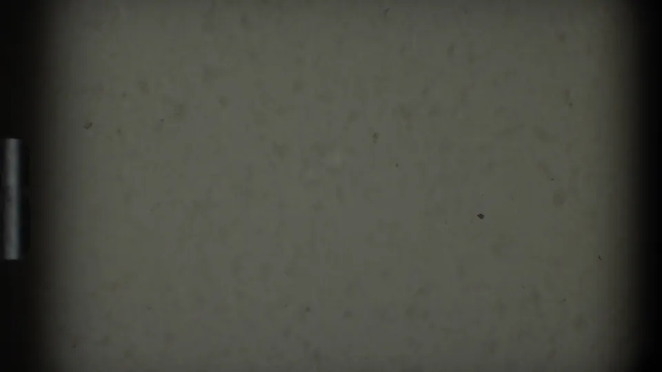 1968 8mm home-movie start frame from Toledo metadata, showing a dim off-white surface with grain, dust, and dark gate edges.
