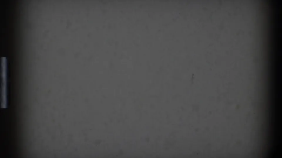1968 Toledo 8mm start-screen frame with muted gray exposure, central shadowing, dust specks, and worn film texture.