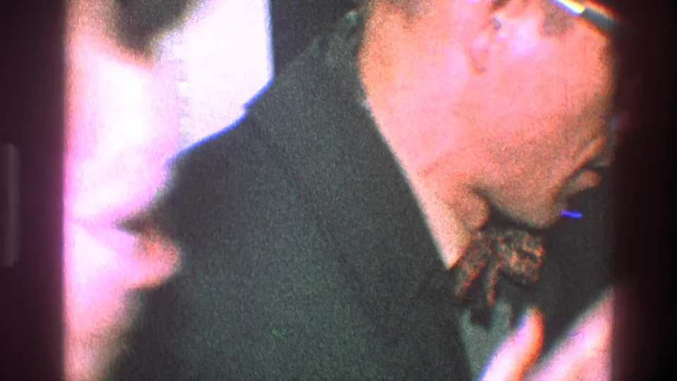 The 1968 Toledo footage shows the man bending toward a partially visible woman, suggesting an intimate goodbye in a private interior.