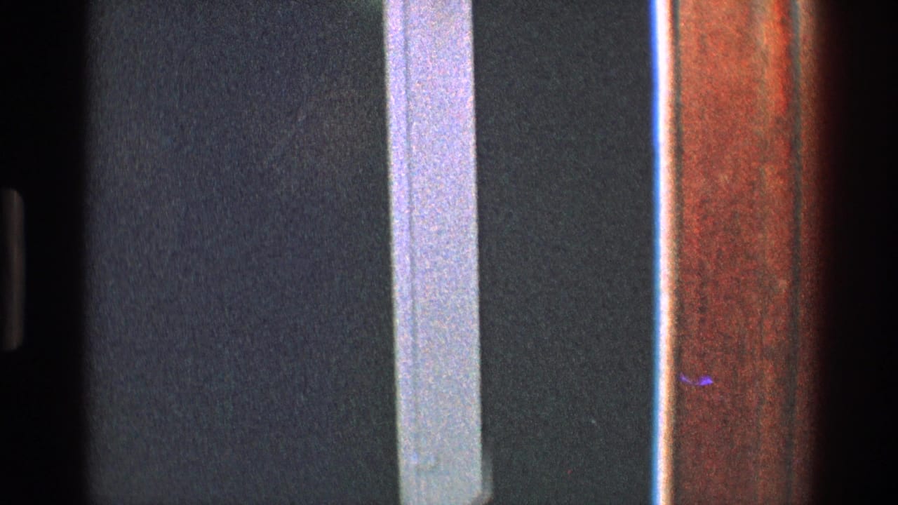 Doorway trim and dark interior wall fill the frame with no clear face visible.